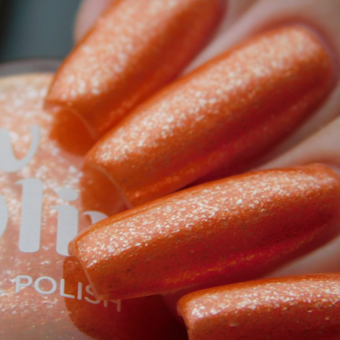 Closeup of nails painted in Coral orange nail polish