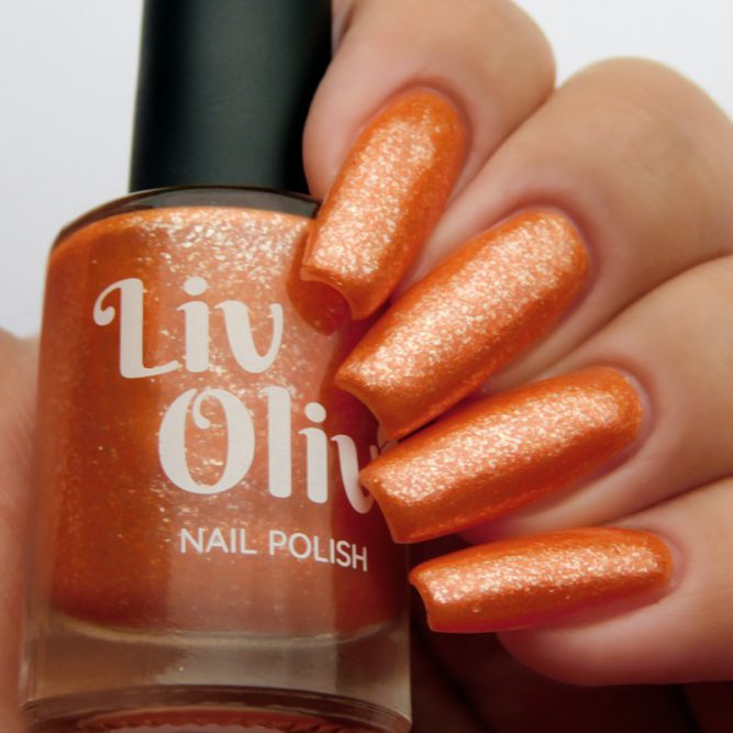Closeup of nails painted in Coral orange nail polish