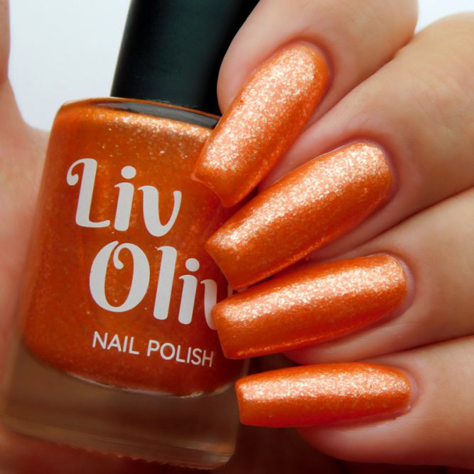 Closeup of nails painted in Coral orange nail polish