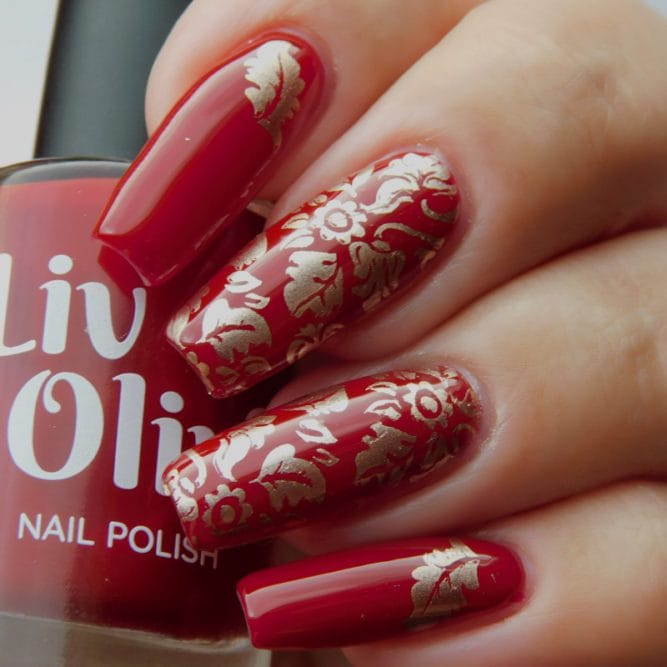 Scarlett red nail polish with gold leaf nail art