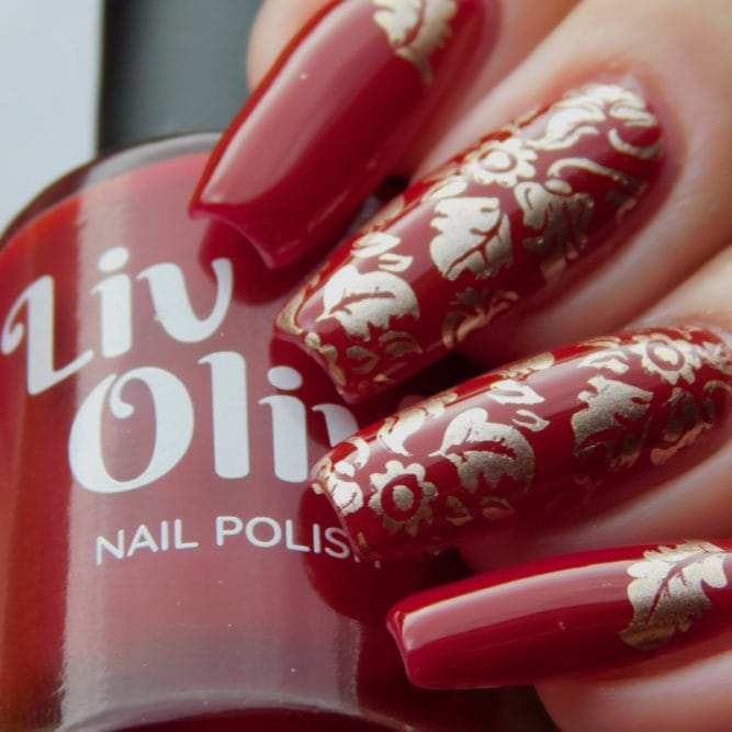 Scarlett red nail polish with gold leaf nail art