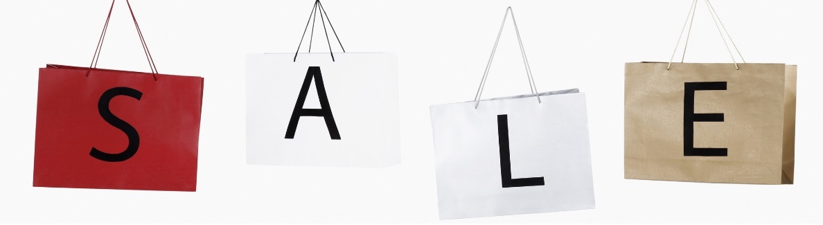 Four paper bags spelling out S A L E