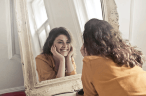 woman smiling in mirror