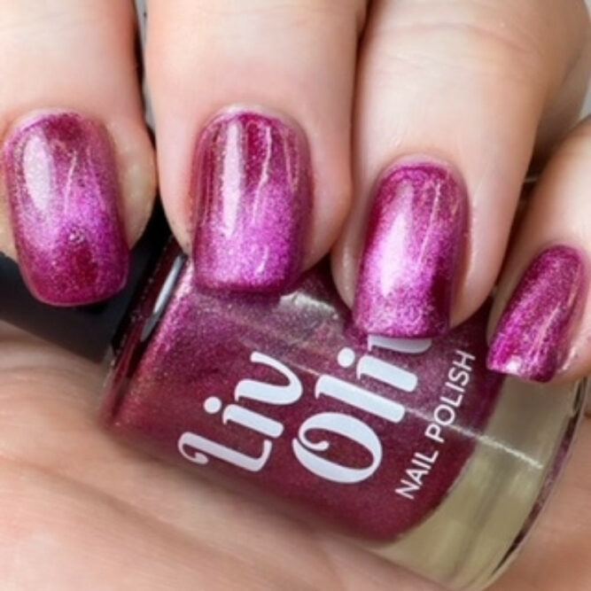 close up of pink and silver magnetic nail polish with glass bottle
